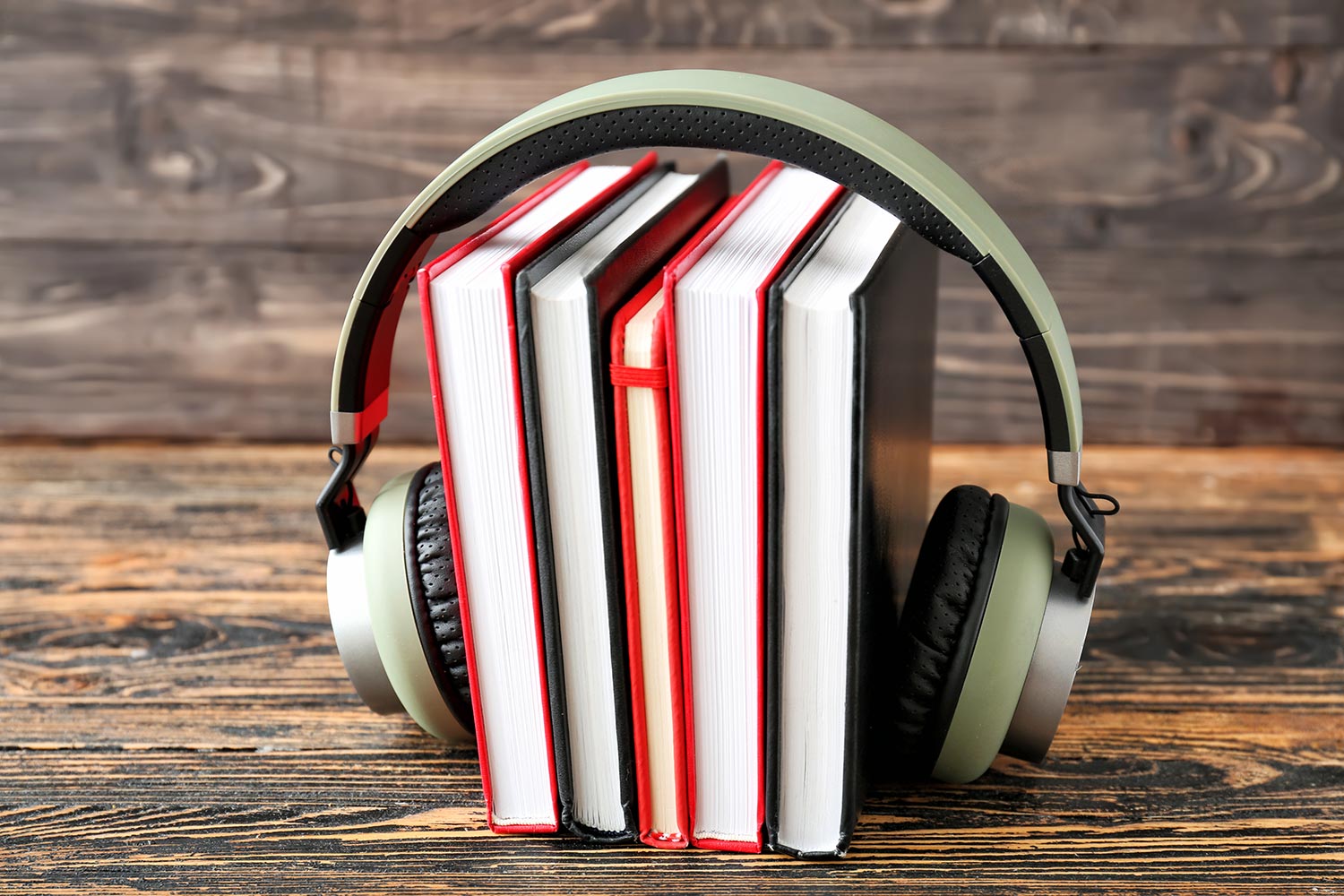 A photo of a pair of headphones on a pile of books